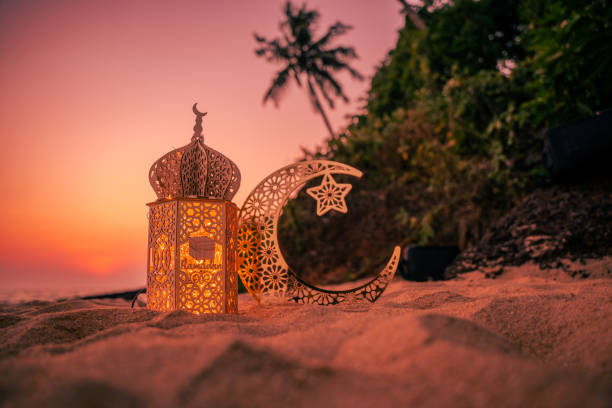 istock Lantern with crescent moon shape on the beach with sunset sky, 2024 Eid Mubarak greeting background, 2021712800