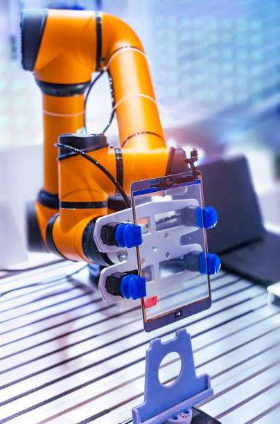 istock Industrial robot with vacuum suckers with tablet computer or mobile cell phone assembly 2021714852