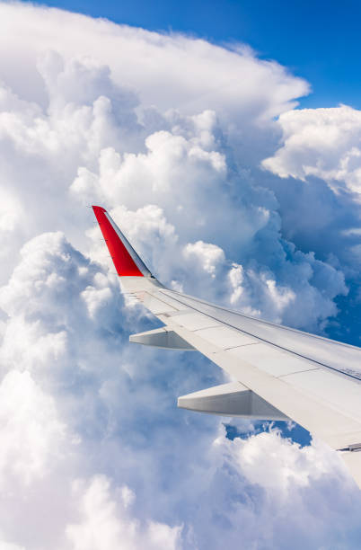 istock View from the airplane window at a beautiful cloudy sky and the airplane wing 2021761903