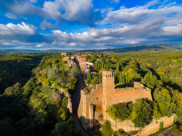 Rocca di Tentennano overlooks the Tuscan landscape with mist and vibrant foliage