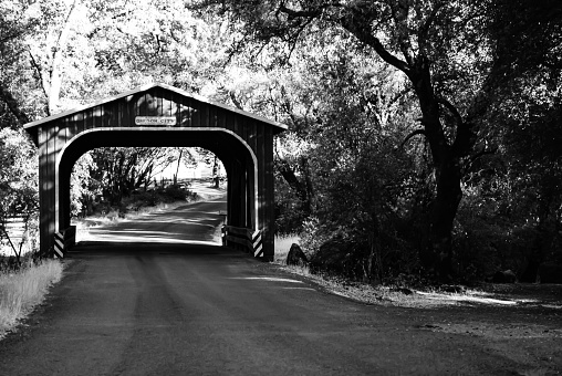 Rural covered bridge in Northern California, rendered in black and white