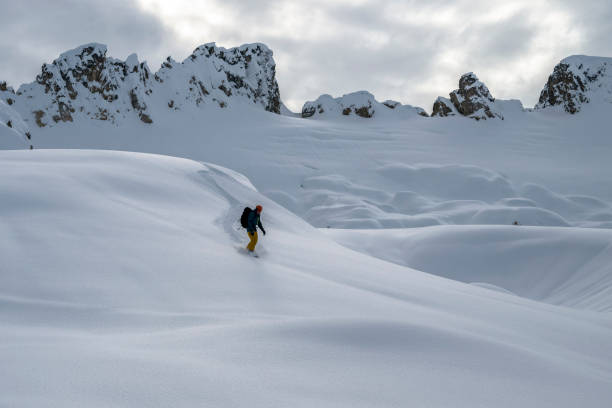 istock Backcountry snowboarder descends mountain 2021828331