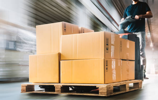 istock Motion Speed of Workers Unloading A Package Boxes on Pallets in Warehouse. Electric Forklift Pallet Jack Loader. Supplies. Supply Chain Shipment Goods. Distribution Warehouse Shipping Logistics 2021828335