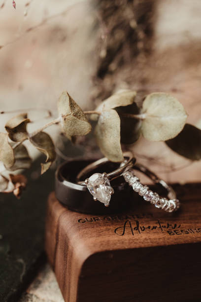 istock Diamond wedding rings and band with greenery 2021834993