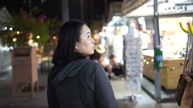 Asian woman shopping in the night market of Thailand
