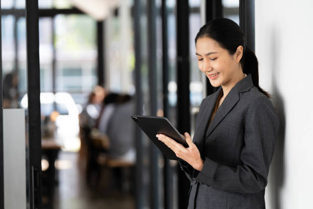 istock Successful business woman looking confident and using digital tablet 2021845291