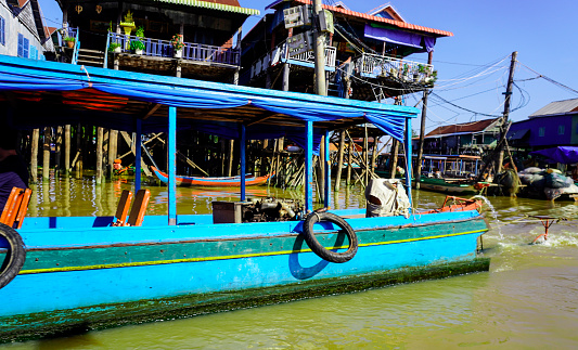 Siem Reap, Cambodia -December 11, 2023 : boat trip on the  River in Cambodia. Fishing villages and houses on the water