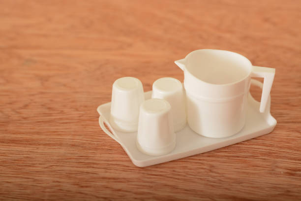 Tea cup toy set on a wooden table. Kids tea coffee serving set