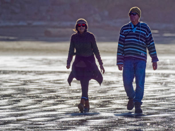 The Pacific Rim National Park on Vancouver Island on April  28, 2023:  Senior couple walking along the shoreline of Pacific Rim National Park on Vancouver Island, British Columbia