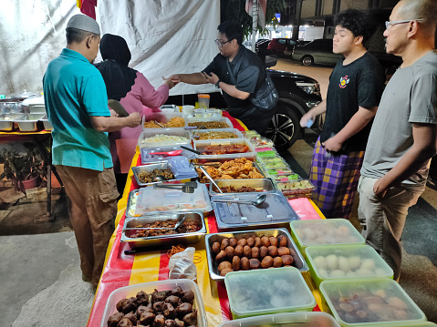 Taman Koperasi Polis 1, Kuala Lumpur, Malaysia- Feb 16, 2024: A morning booth sells bakers' confections and greasy fried meals to consumers for breakfast.