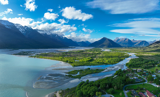Experience breathtaking vistas from above in at Glenorchy, New Zealand, where mountains meet water in a stunning landscape. Aerial beauty awaits.