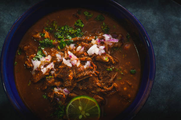 istock Bowl of Mexican Beef Birria Stew on Blue Background 2021972523
