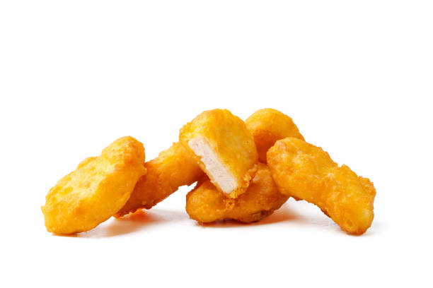 istock Pile of fried chicken nuggets isolated on white 2021980290