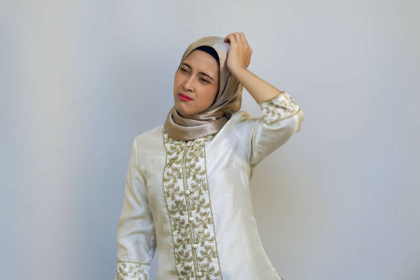 young muslim woman posing in white background studio for ramadan or eid concept - pusing imagens e fotografias de stock