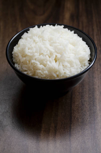 istock Rice in cup on wooden table wth copy space 2022001141
