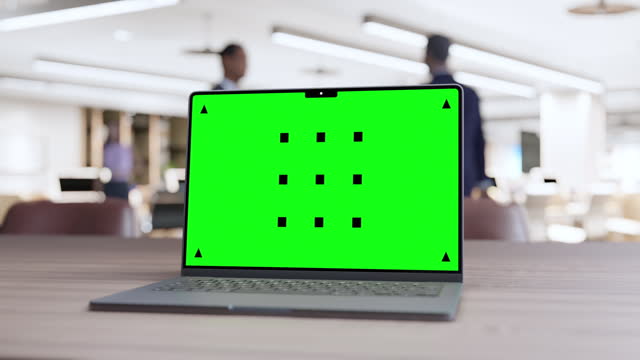 Laptop with Green Screen on Office Desk