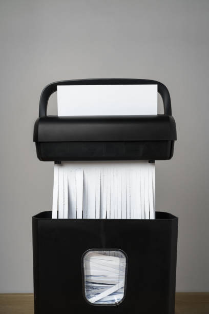 istock Black paper shredder cutting paper on gray background 2022028270
