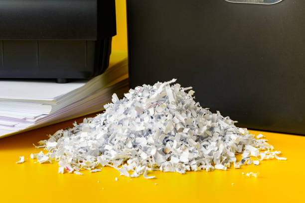 istock Office paper shredder on yellow studio background 2022028555