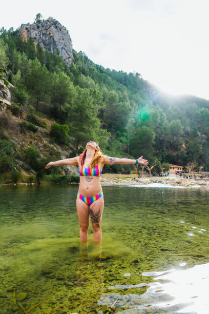 istock Woman in bikini enjoying the sun in a river. 2022047009