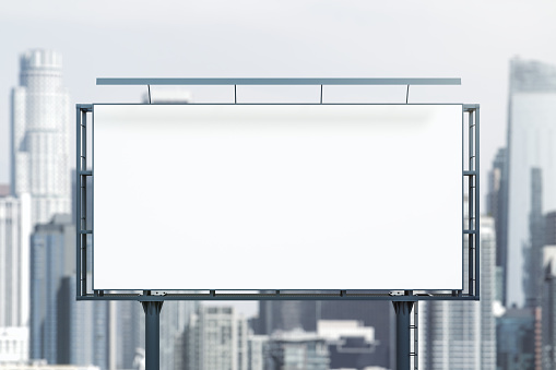 Blank white horizontal billboard on cityscape background at daytime, front view. Mockup, advertising concept