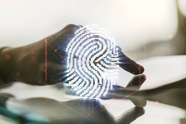 istock Multi exposure of abstract fingerprint scan interface and hand working with a digital tablet on background, digital access concept 2022061558
