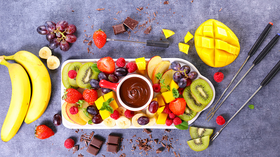 Chocolate fondue pot with various fresh fruits