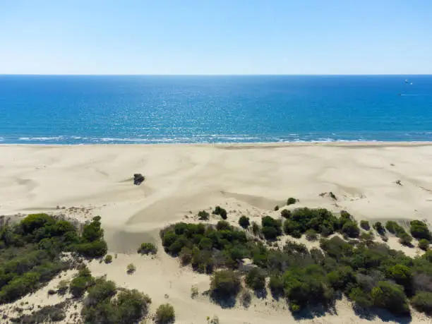 Photo of Beautiful sandy beach of Patara with blue sea, Kalkan, Antalya, Turkey. Drone view of the sandy beach, the length of the Mediterranean coast and the longest sandy beach