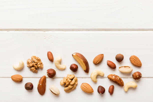 istock Composition of nuts , flat lay - mix hazelnuts, cashews, almonds on table background. healthy eating concepts and food background 2022086136