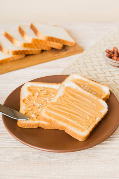 Peanut butter sandwiches or toasts on light table background.Breakfast. Vegetarian food. American cuisine top view vith copy space