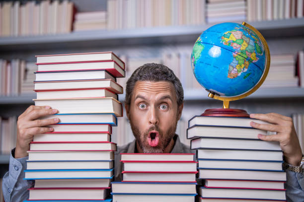 istock education and knowledge. man teacher in class. school education. man nerd with school book. school literature education. man in classroom. bookworm in school library. Discover new realms in books 2022091388