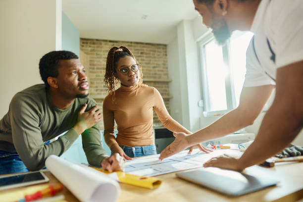 istock African American couple talking about plans with their manual worker. 2022092458