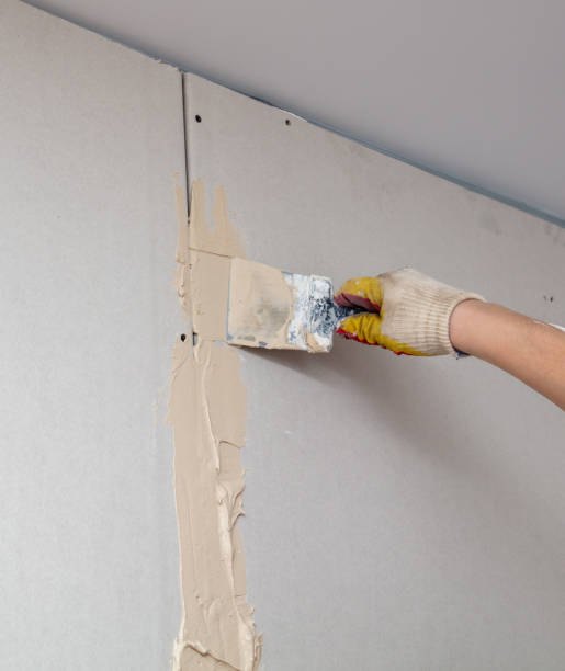 istock A man is plastering a wall in the house 2022095611