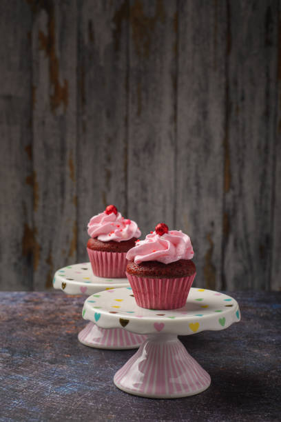 istock Cupcakes on small ceramic plate with wooden bottom with copy space. Product photo. 2022096686