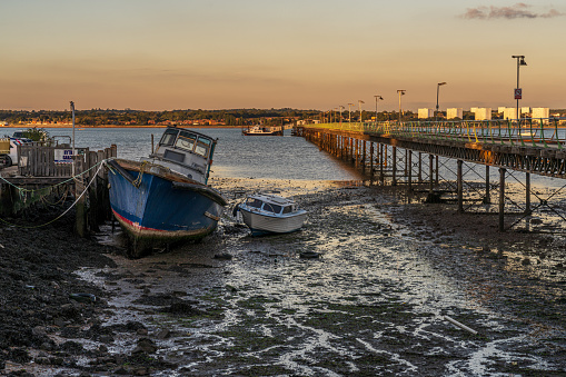Hythe, Hampshire, England, UK - September 29, 2022: Evening light at Hythe Pier and a ferry departing