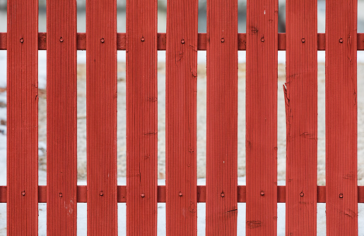 A red wooden fence found on the road. Picket Fence