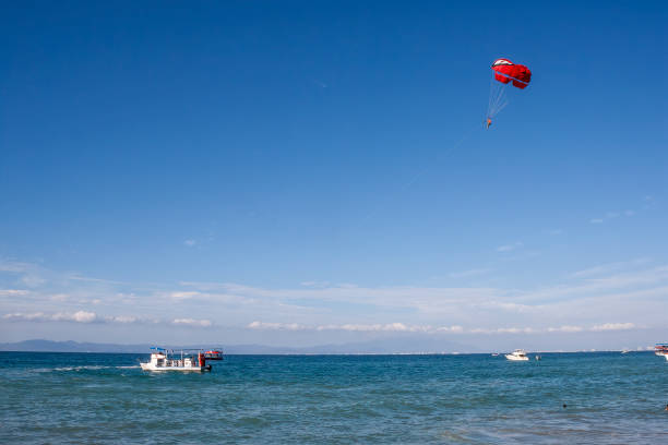 Las Animas, Puerto Vallarta, Jalisco , Mexico, January 16th, 2024: A person parasailing in Playa Las Animas