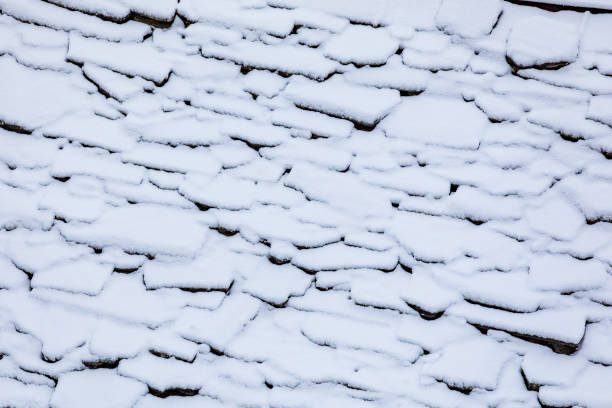 Snow on the roof of a renovated cabin in Valchiavenna.