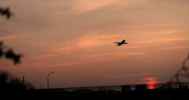 istock Silhouette of airplane take off at sunset 2022104749