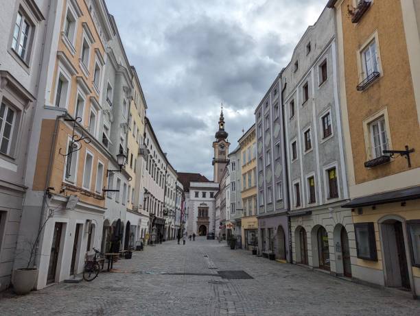 istock Cobblestone street leading to a tall clock tower: Linz, Austria 2022111175