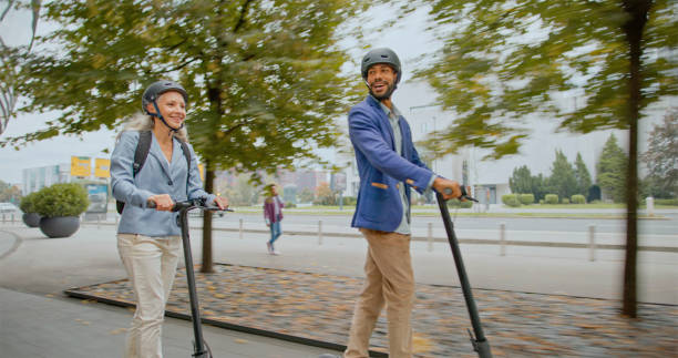istock Business people riding e-scooters on sidewalk 2022111713