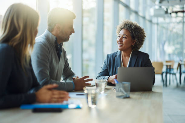 istock Happy insurance agent talking to her customers in the office. 2022120713