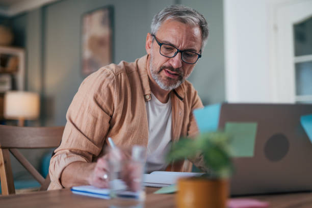istock mature man working from home or sorting the home finances. 2022126477
