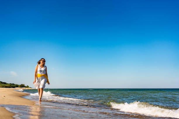 Beautiful woman walking on beach