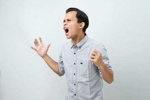Angry mad asian indonesian man expression on isolated bakcground