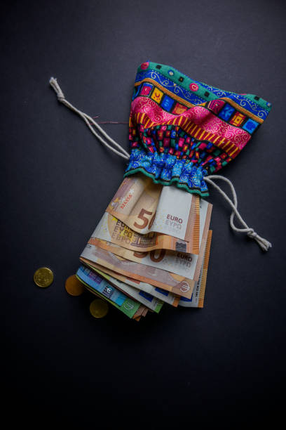 indian money bag full of money on a black background - religious mark photos photos et images de collection