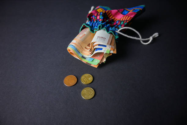 indian money bag full of money on a black background - religious mark photos photos et images de collection