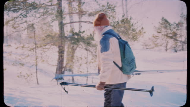 Retro Footage of Elderly Couple Stretching Arms after Ski Trip in Forest