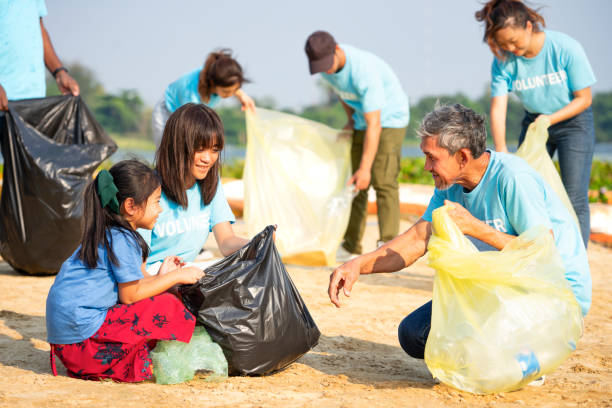 istock adult help children collect and separate plastic bottle for reuse 2022162964