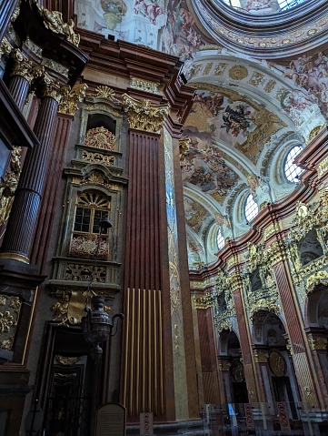 The beautiful interior of Melk Abbey with golden accents and intricate frescoes