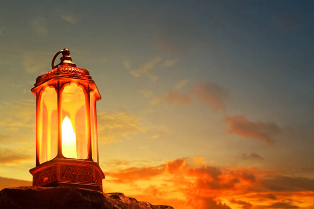 Arabic lantern on top rock mountain at beautiful sunset sky with cloud, Ramadan kareem background